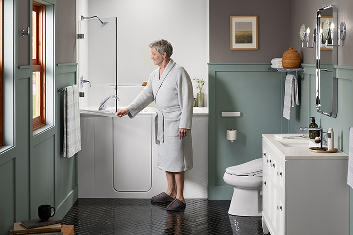 Man opens the KOHLER Bath Screen of the Shower Package